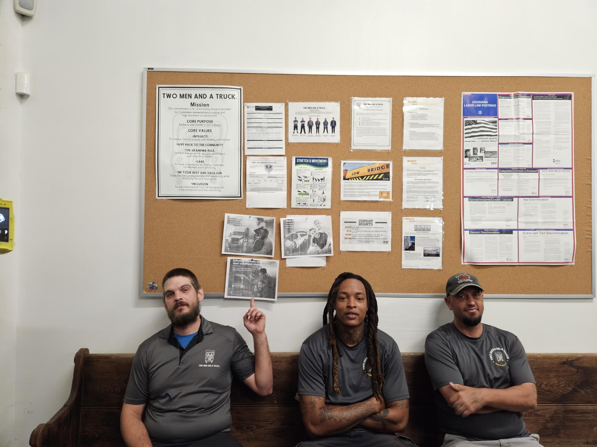 Robert, Dareon, and Joseph in front of safety board