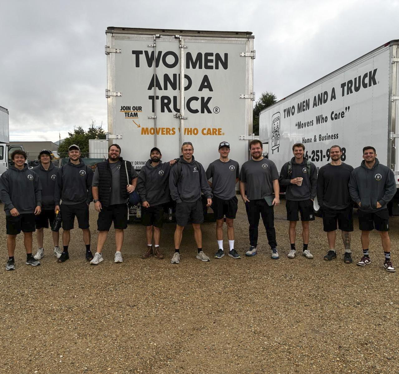 Two men and a truck crew standing in front of a truck