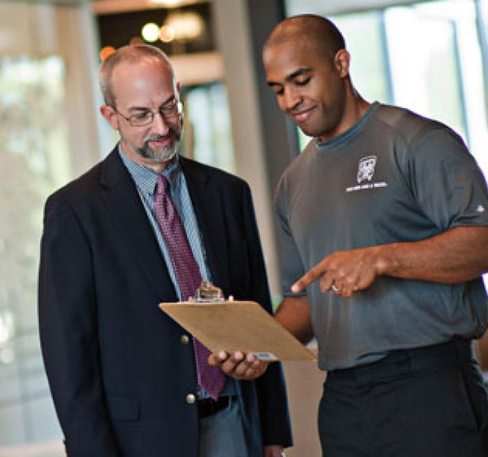 two men and a truck professional company mover talking with an office manager