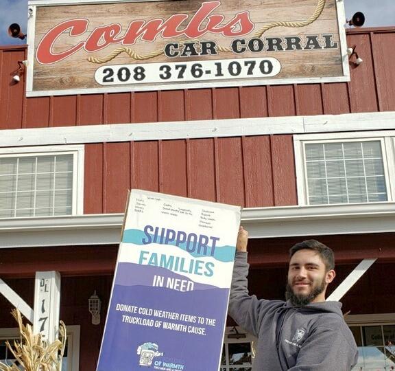 Mover holding donation box in front of Comb&#039;s Car Corral