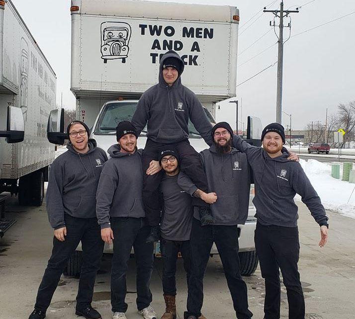 Team photo of two men and a truck movers