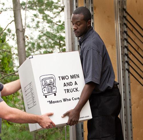 two men and a truck mover receiving a box during loading