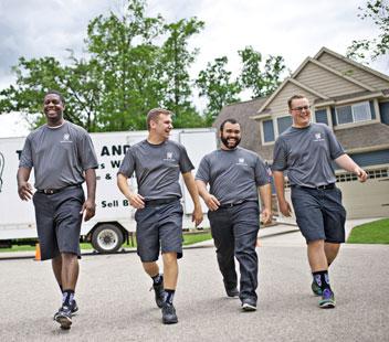 two men and a truck company movers in a neighborhood