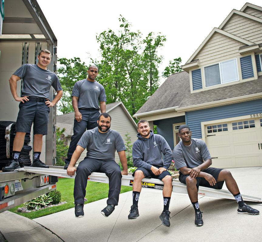 movers sitting on a truck ramp