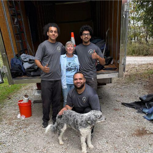 three movers with customer and her dog 