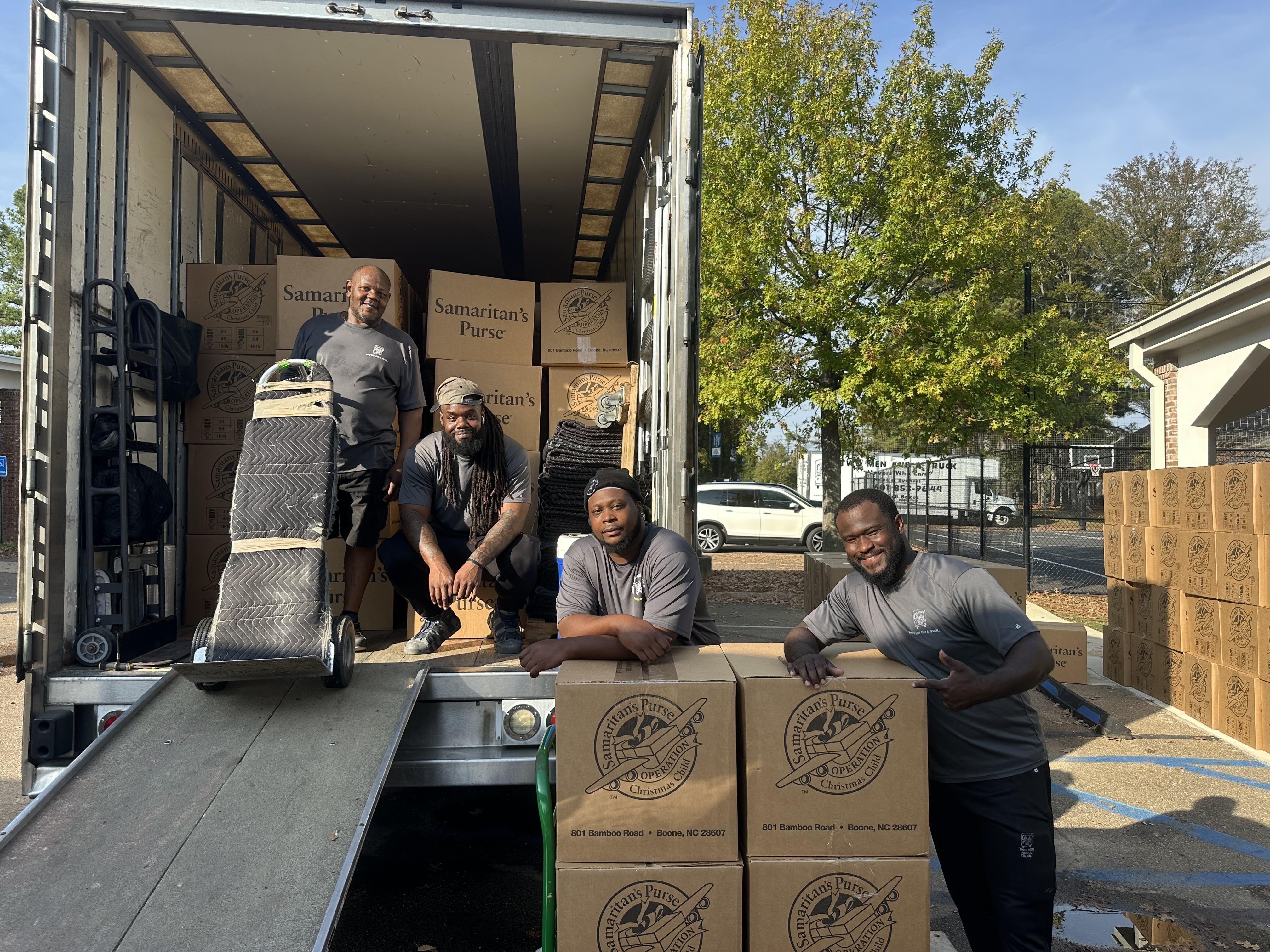 Movers giving back to community by loading Operation Christms child boxes 