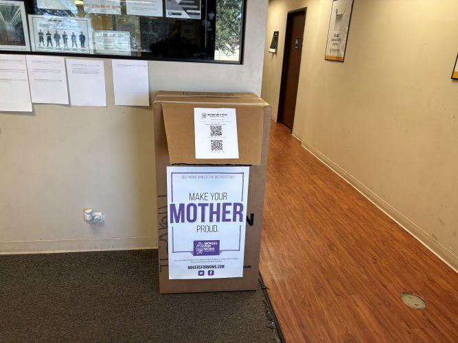 A movers for moms box in an office hallway