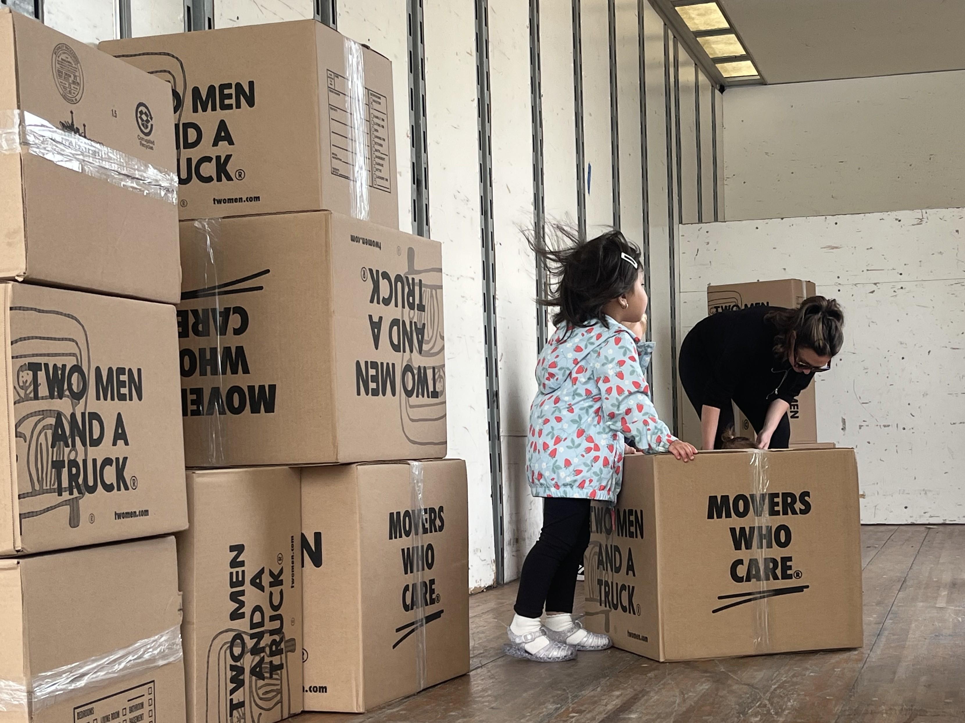 Child playing with boxes at Touch A Truck event