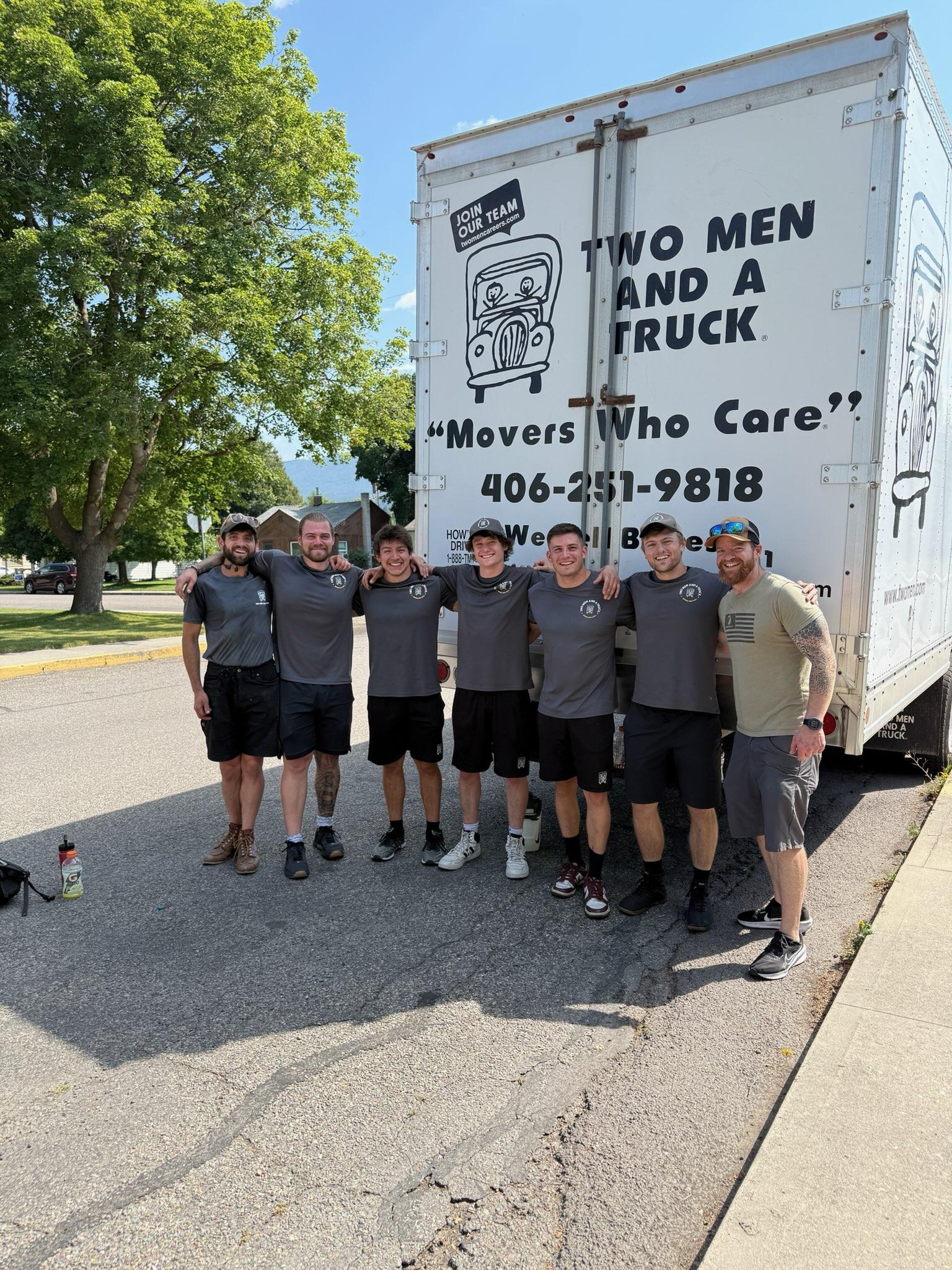 Crew standing in front of a truck with happy customer