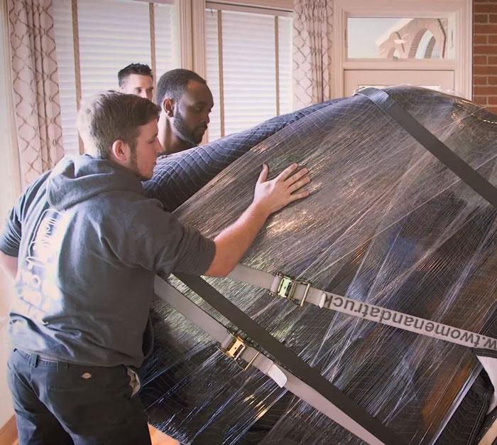movers transporting a piano