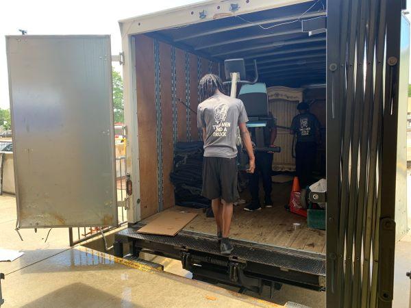 The Movers Who Care unloading furniture at FODACs warehouse.