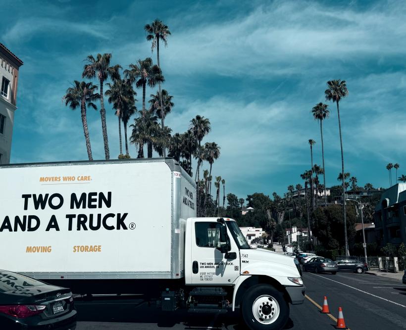 Hollywood with Hollywood Hills in background two men and a truck 