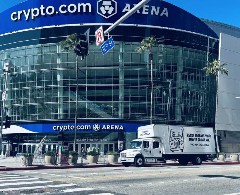 Moving truck parked in front of a stadium