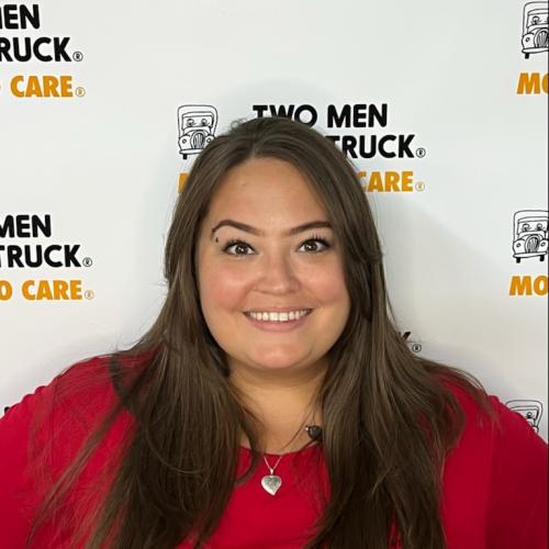 Kayla standing in front of white TWO MEN AND TRUCK®  background