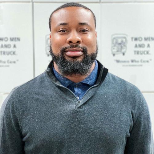 Duval standing in front of white moving boxes
