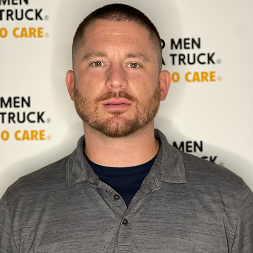 Josh standing in front of TWO MEN AND A TRUCK logo