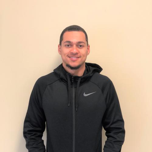 Picture of Move Manager Andrew Paulino with fresh haircut, black hoodie, smiling 