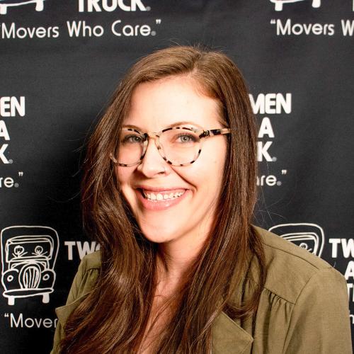 Kirsten standing in front of branded backdrop
