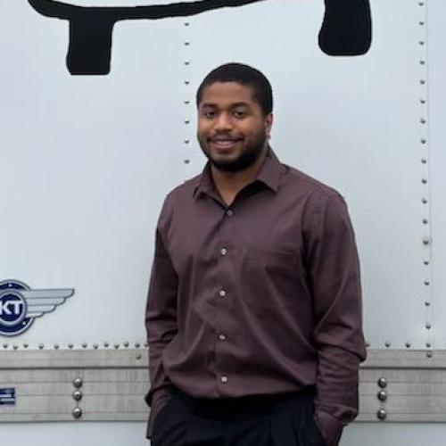 Adrian standing in front of company vehicule