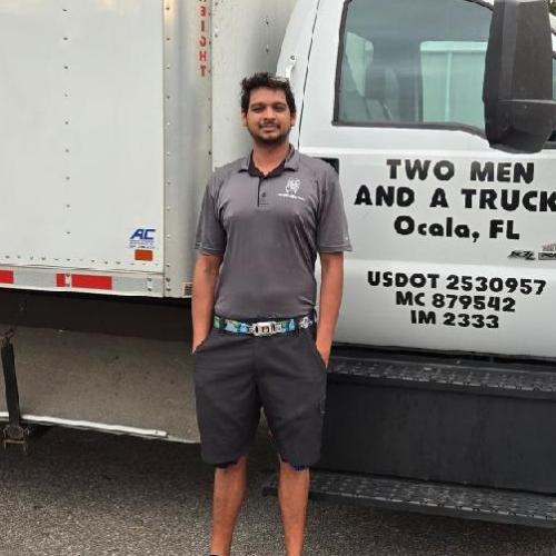 Man standing beside moving truck
