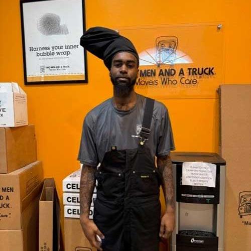 headshot of a mover standing near moving boxes