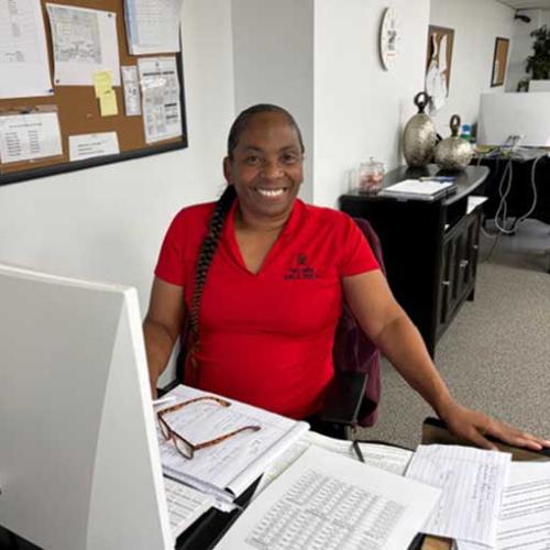 Debbie - customer service representative for two men and a truck sitting at her desk