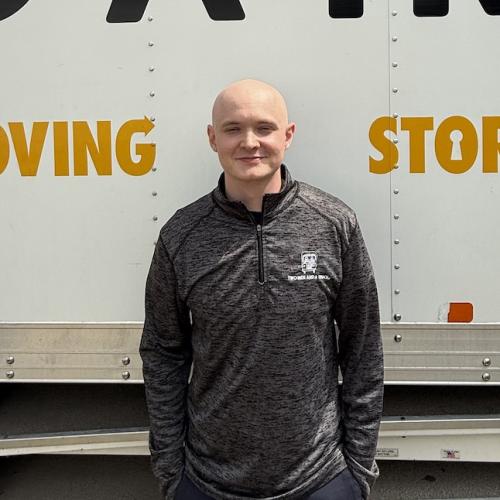 Move consultant standing in front of a moving truck in Austin Texas.