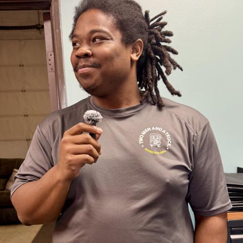 Imara, driver, smiling with microphone
