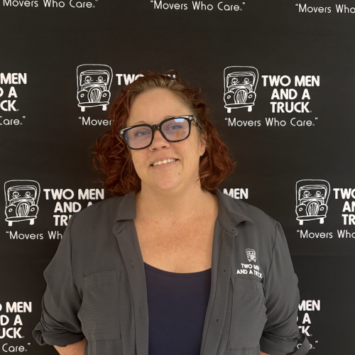 A women standing in front of a branded background
