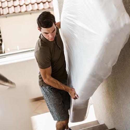 Man carrying mattress