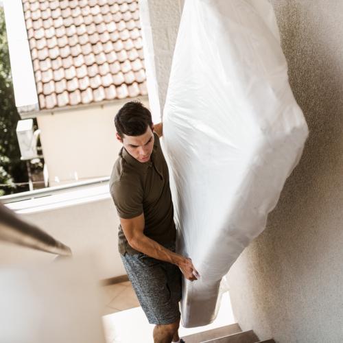 Man carrying mattress