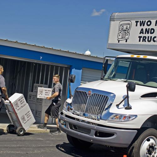 Men moving furniture into storage