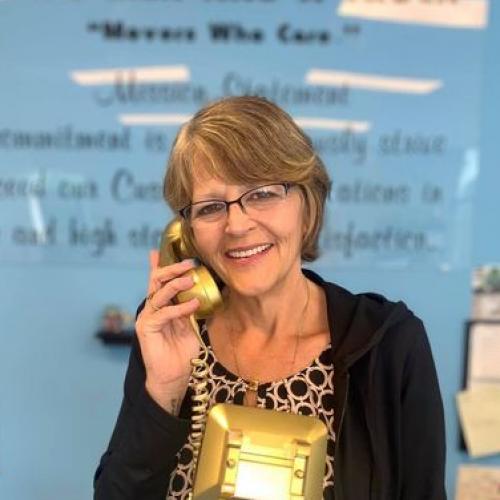 Trish answering a golden phone