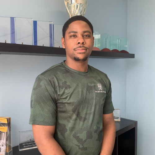 George standing in the office wearing a camo shirt