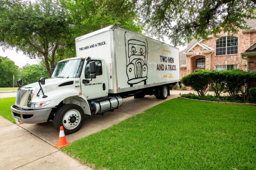 Moving truck parked in driveway