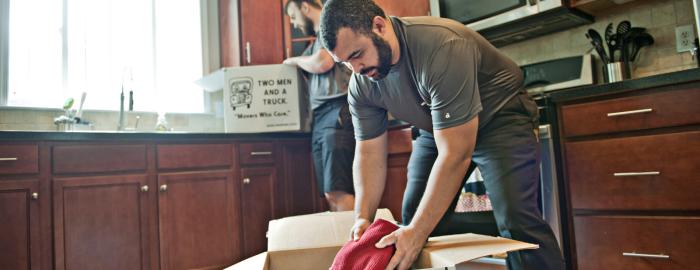 a mover unpacking clothes from a box