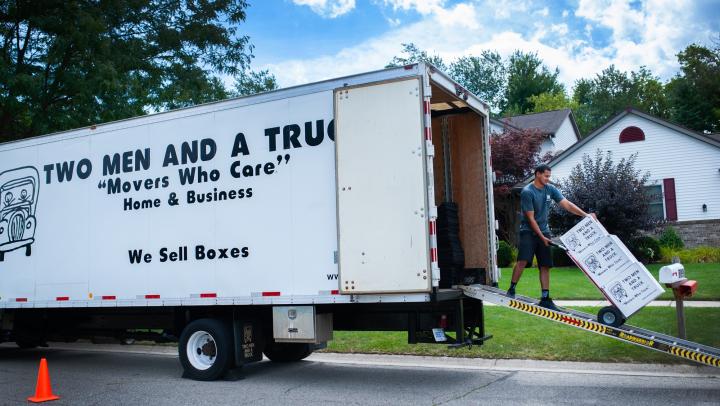 TWO MEN AND A TRUCK mover talking with customers 