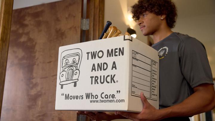 Mover carrying a moving box 