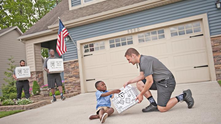 Movers talking with kid during a move