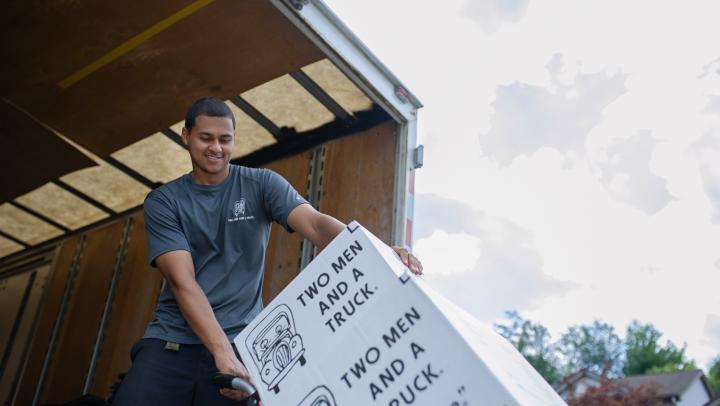 TWO MEN AND A TRUCK mover loading a moving truck 