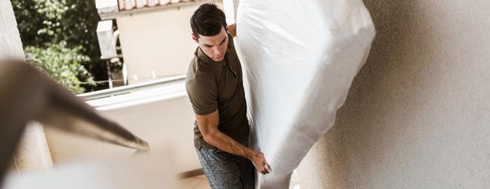 Man carrying mattress