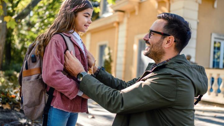 Parent helping their child prepare for a new school year 