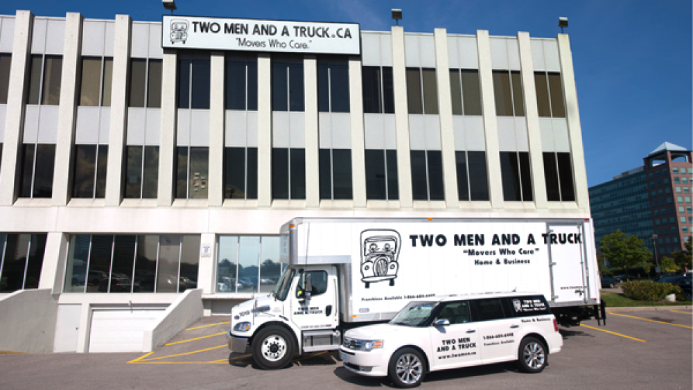 two men and a truck supports bucky on parade