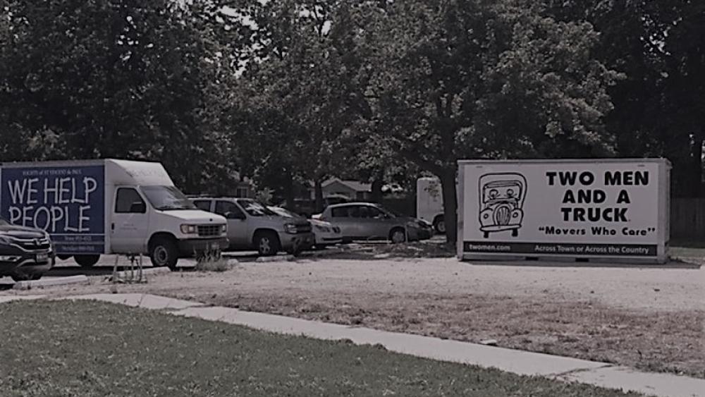 Storage container, cars in parking lot